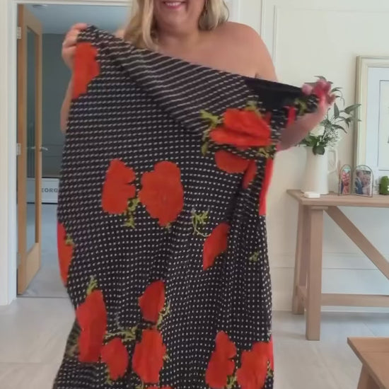 Customer wearing the Black Poppy Sophie Dress with the scarf draped, red poppy and polka dot print