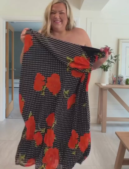 Customer wearing the Black Poppy Sophie Dress with the scarf draped, red poppy and polka dot print